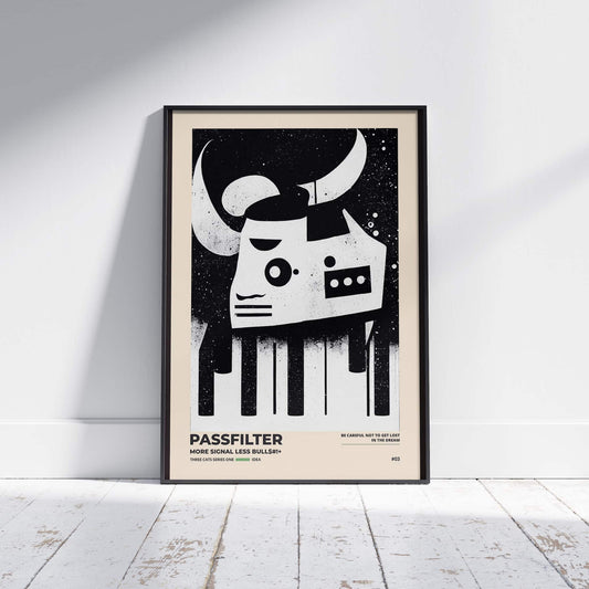 Black framed Passfilter poster sitting on a white wooden floor in a recording studio.