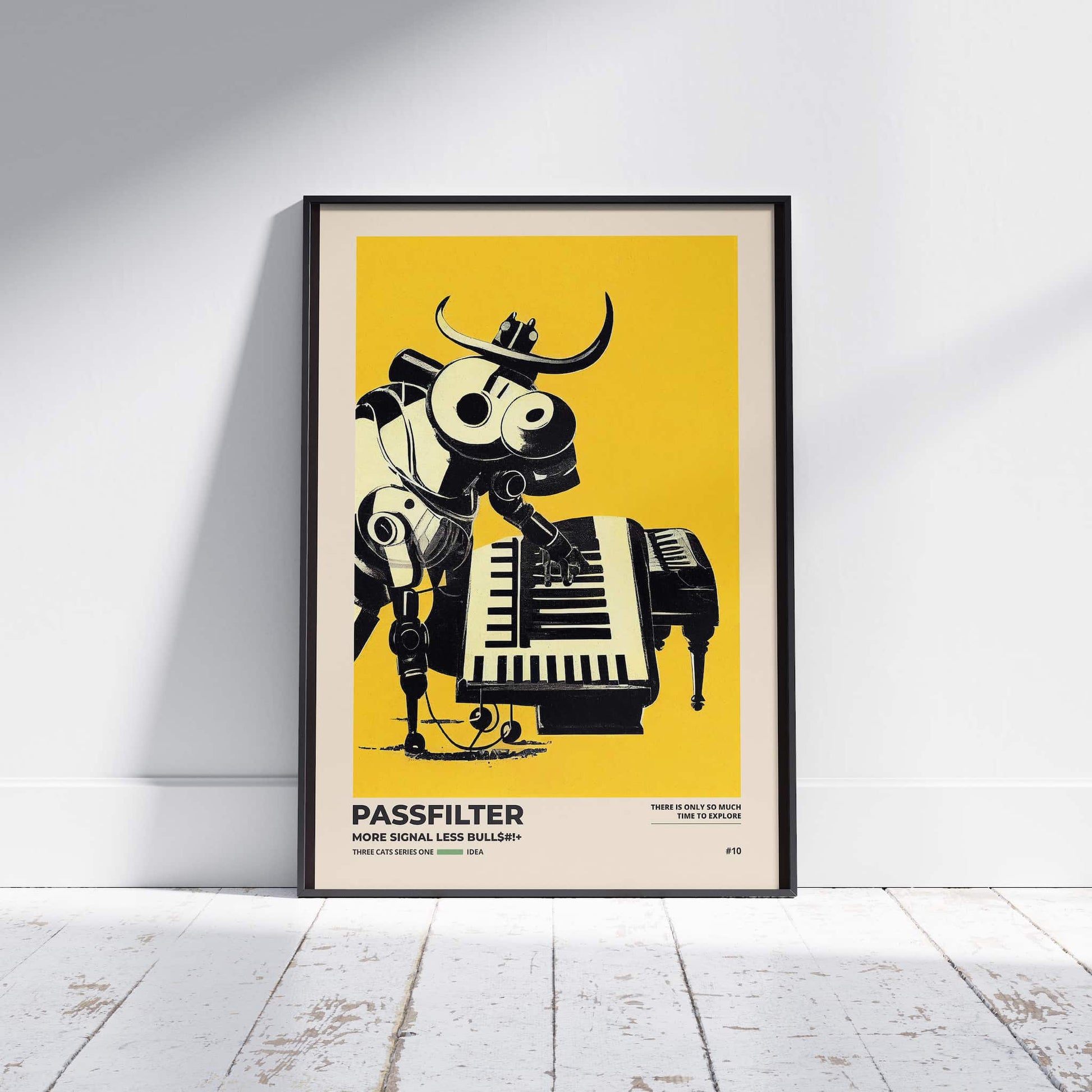 Black framed Passfilter poster sitting on a white wooden floor in a recording studio.