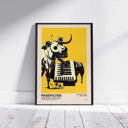 Black framed Passfilter poster sitting on a white wooden floor in a recording studio.