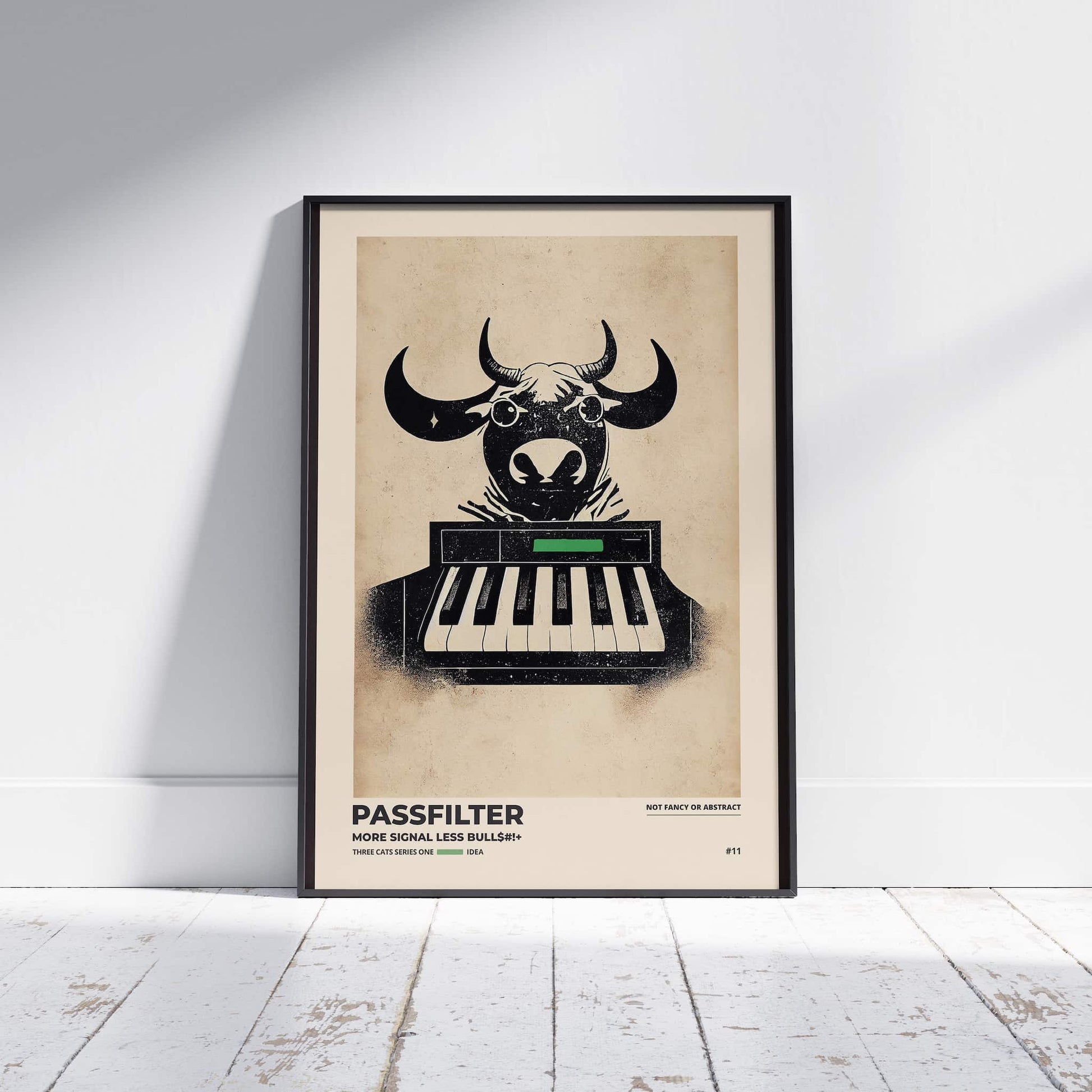 Black framed Passfilter poster sitting on a white wooden floor in a recording studio.