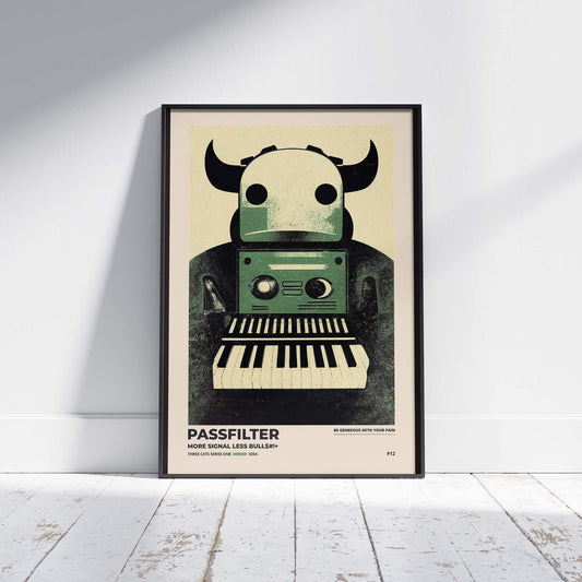 Black framed Passfilter poster sitting on a white wooden floor in a recording studio.