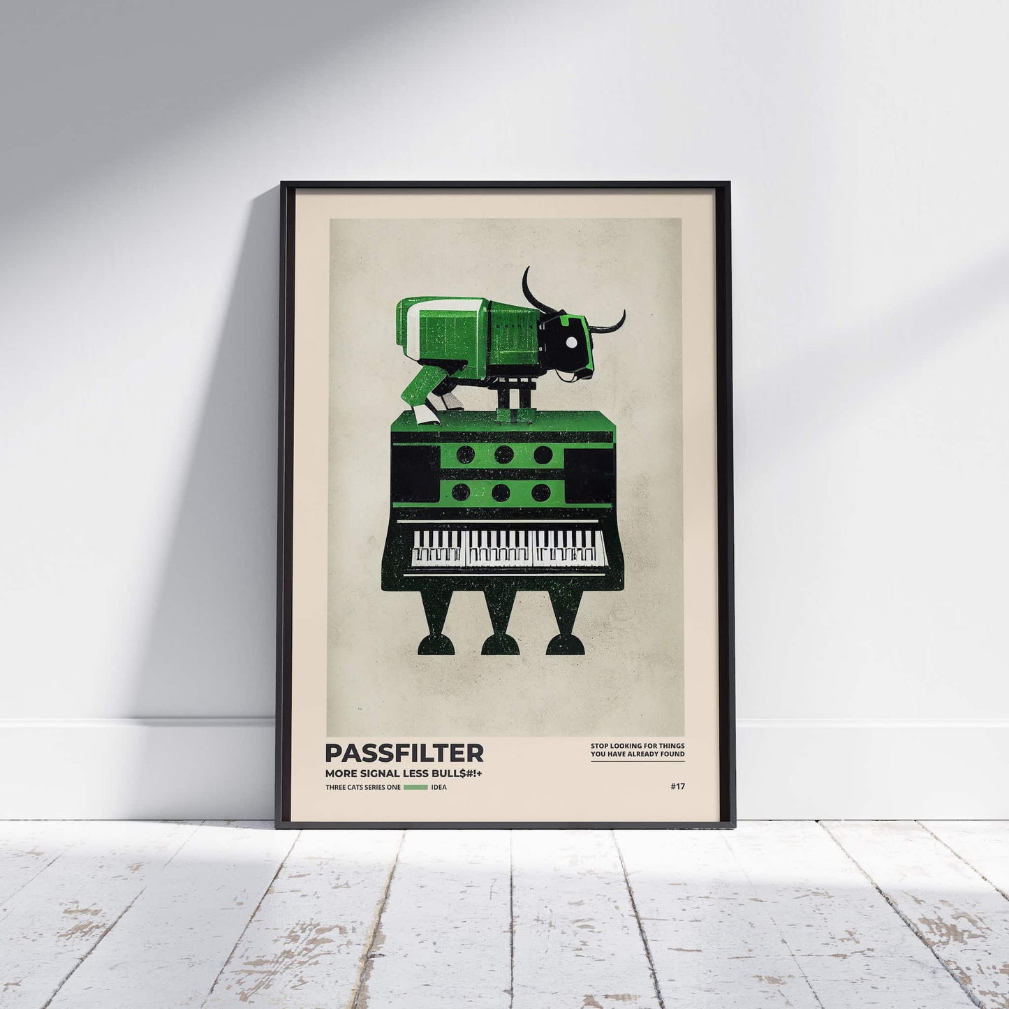 Black framed Passfilter poster sitting on a white wooden floor in a recording studio.