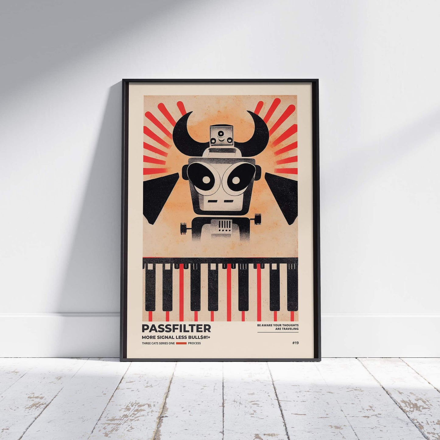 Black framed Passfilter poster sitting on a white wooden floor in a recording studio.