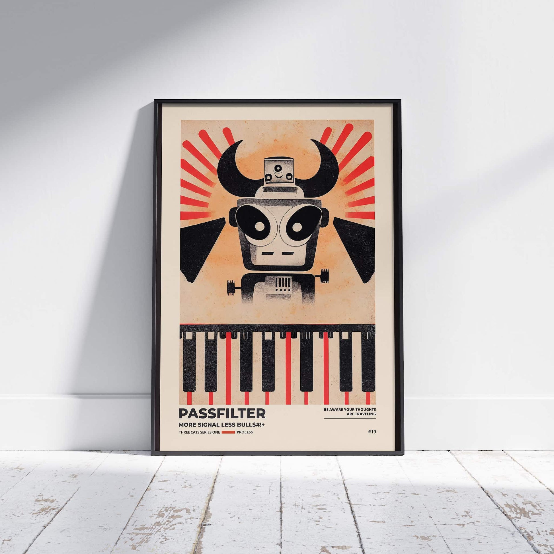 Black framed Passfilter poster sitting on a white wooden floor in a recording studio.