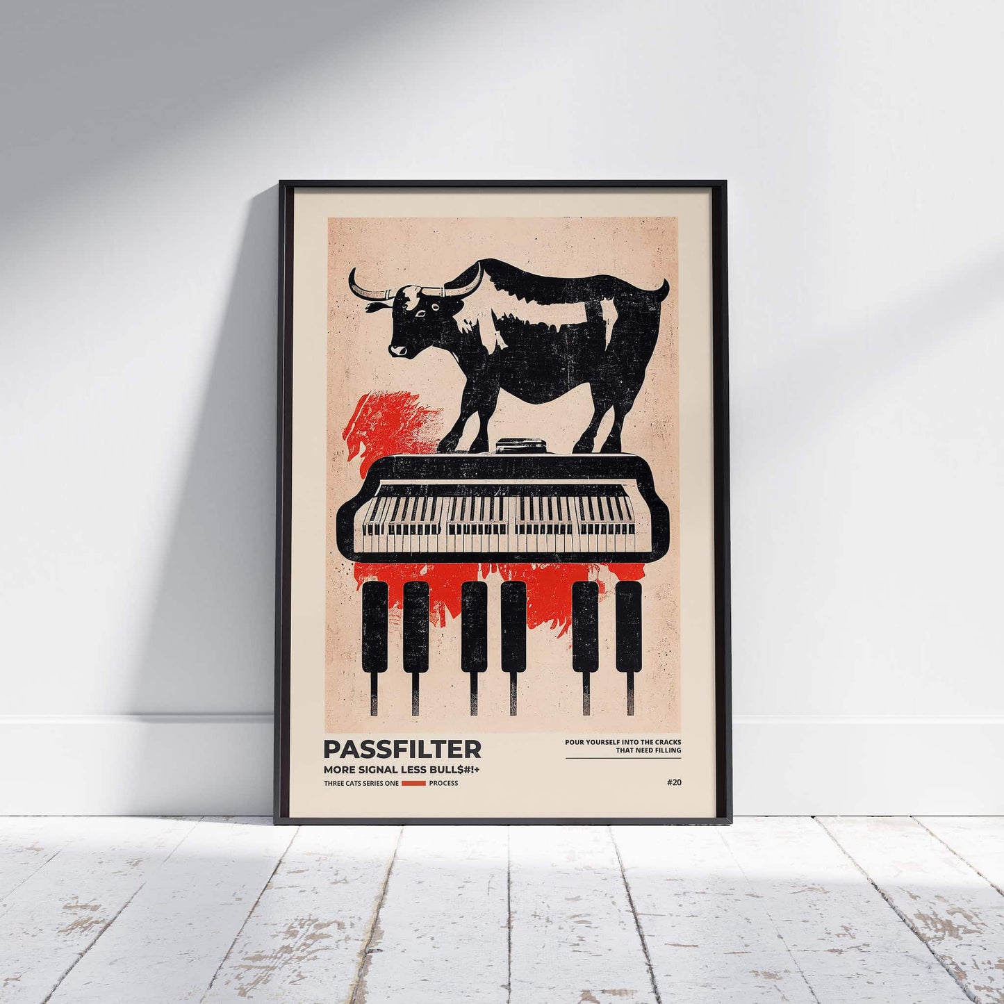 Black framed Passfilter poster sitting on a white wooden floor in a recording studio.