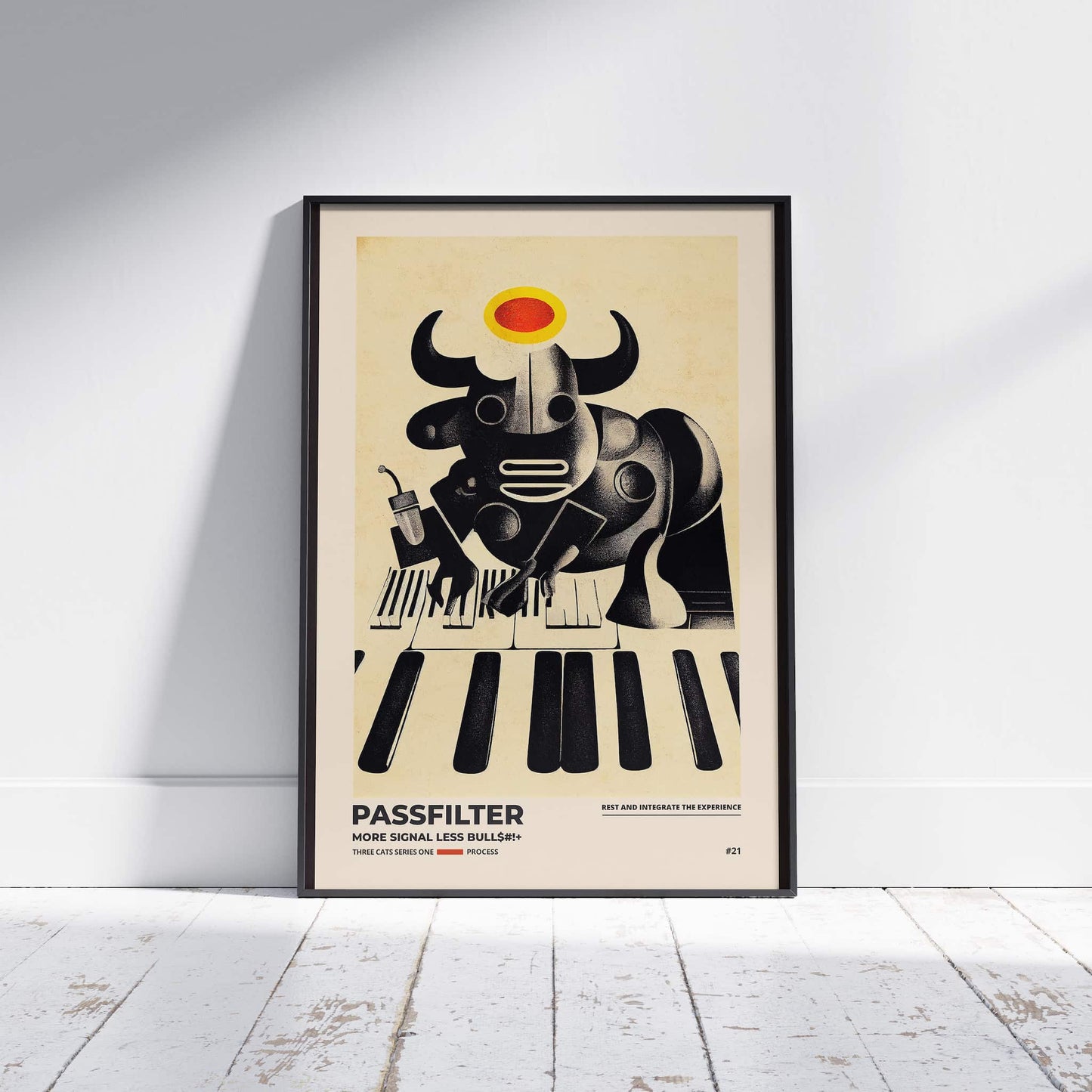 Black framed Passfilter poster sitting on a white wooden floor in a recording studio.