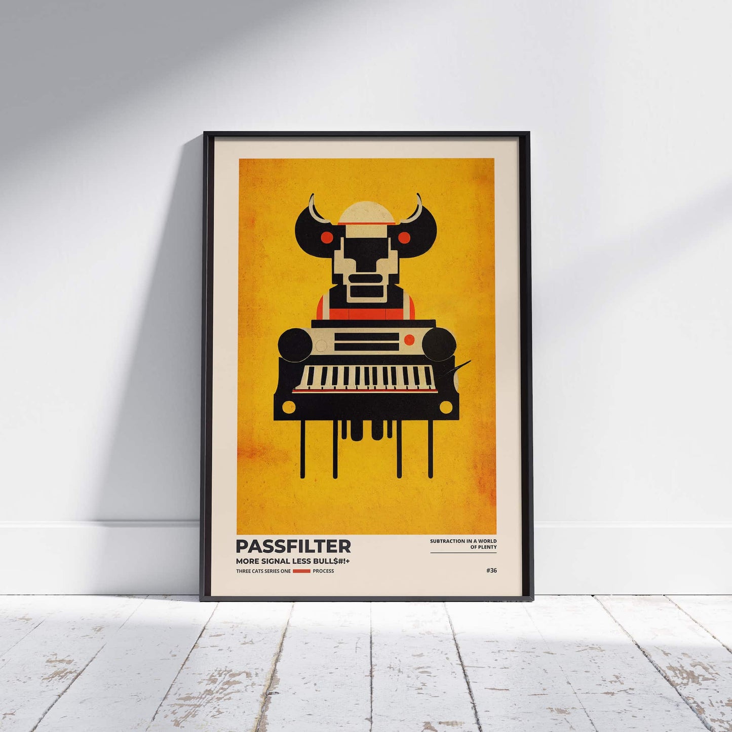 Black framed Passfilter poster sitting on a white wooden floor in a recording studio.