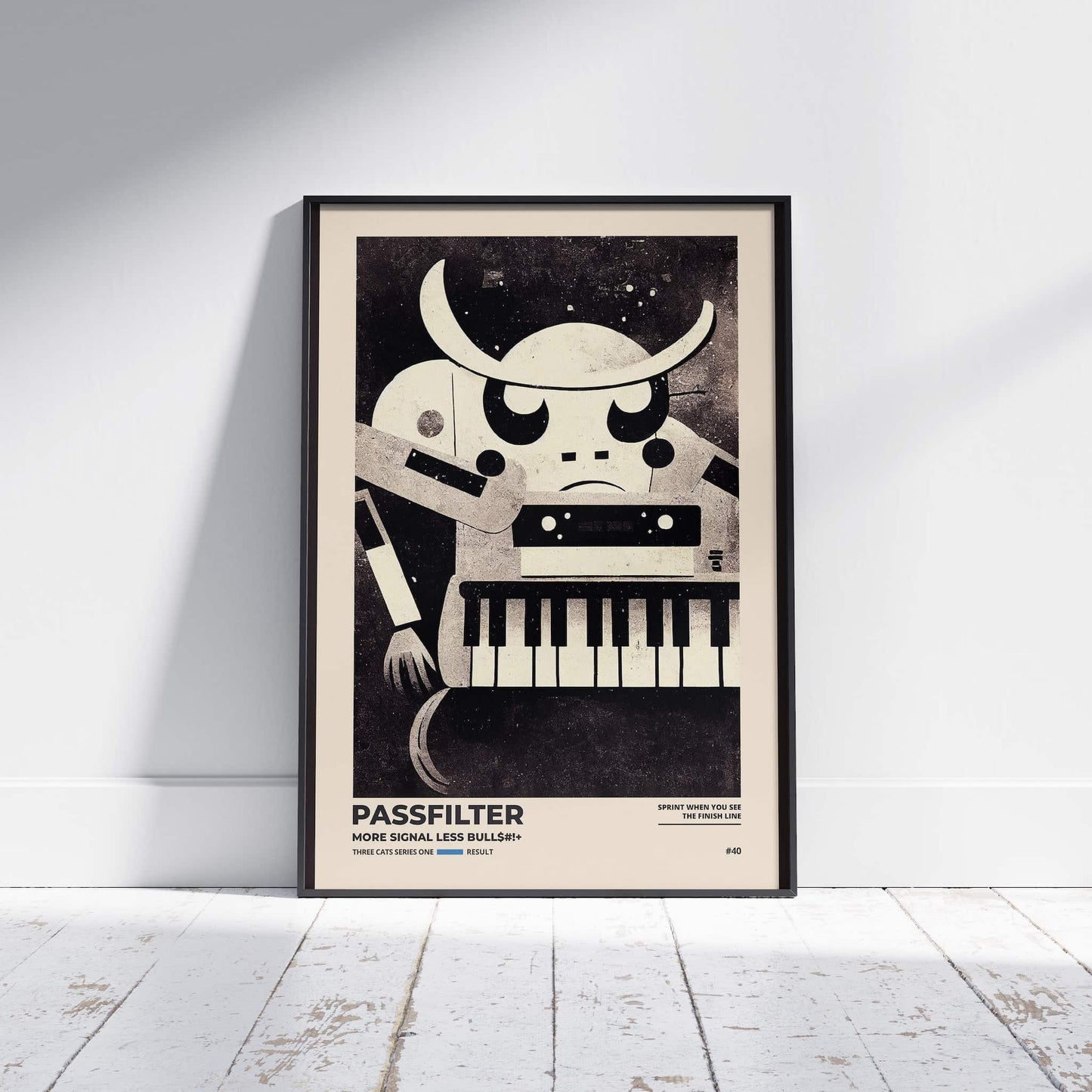 Black framed Passfilter poster sitting on a white wooden floor in a recording studio.