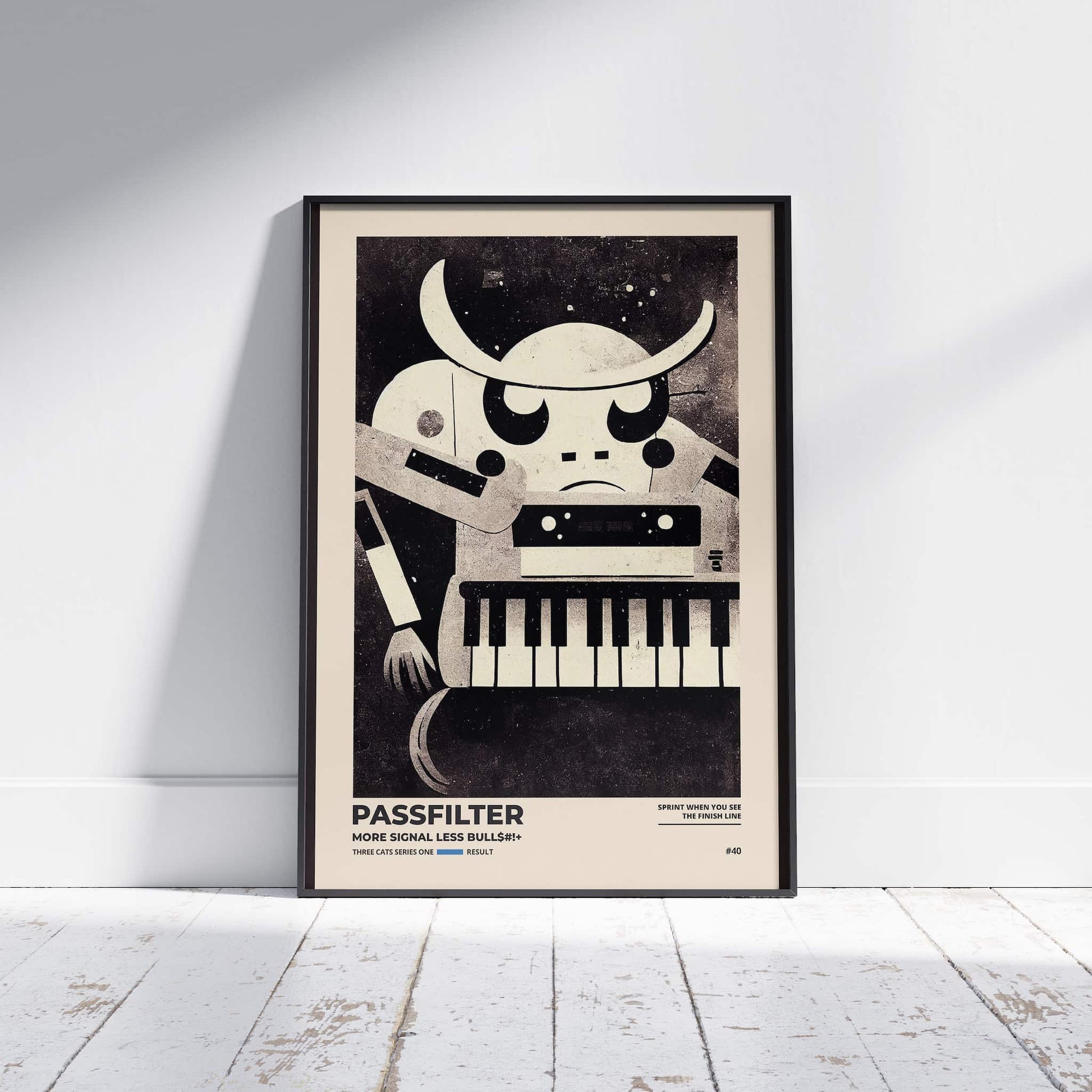 Black framed Passfilter poster sitting on a white wooden floor in a recording studio.