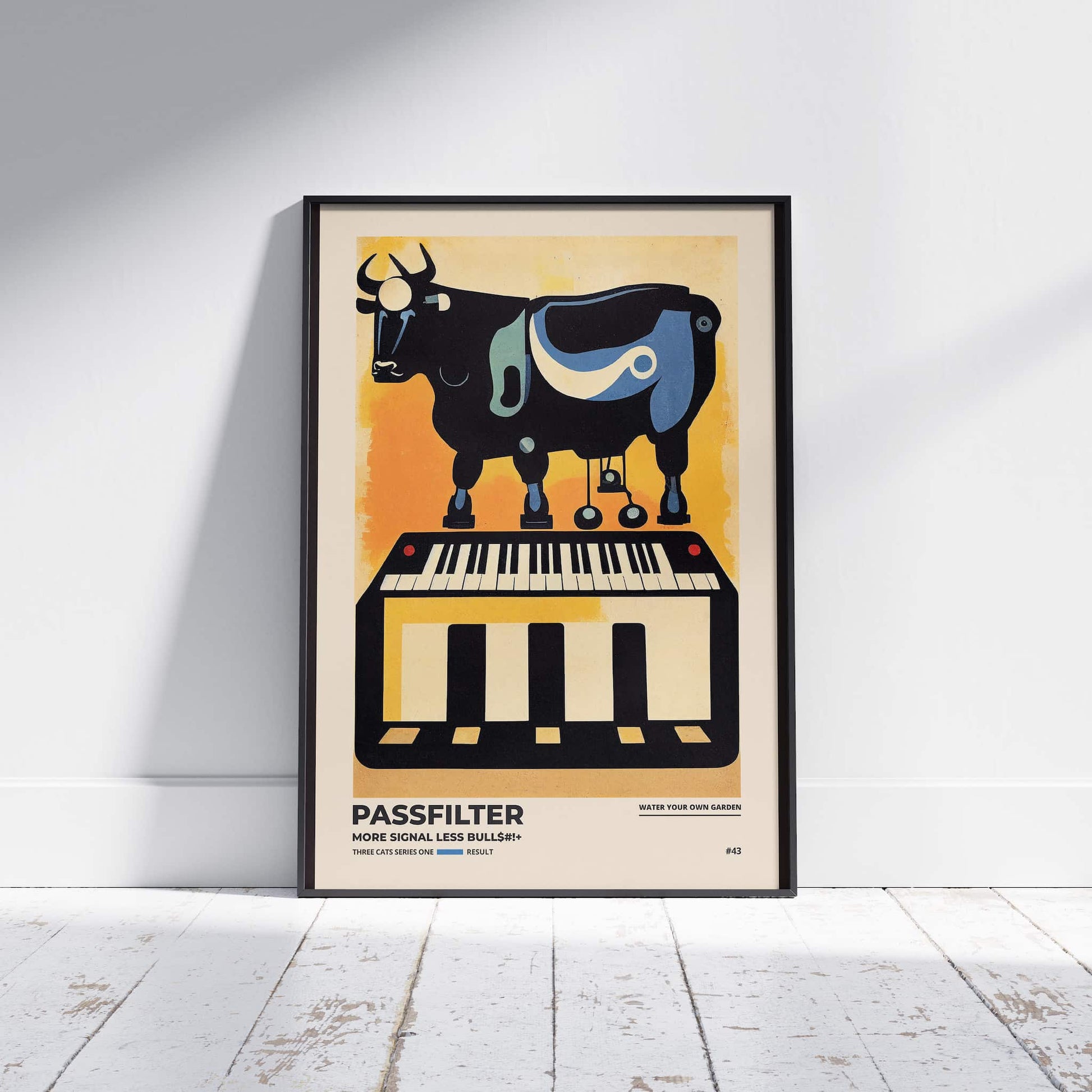 Black framed Passfilter poster sitting on a white wooden floor in a recording studio.