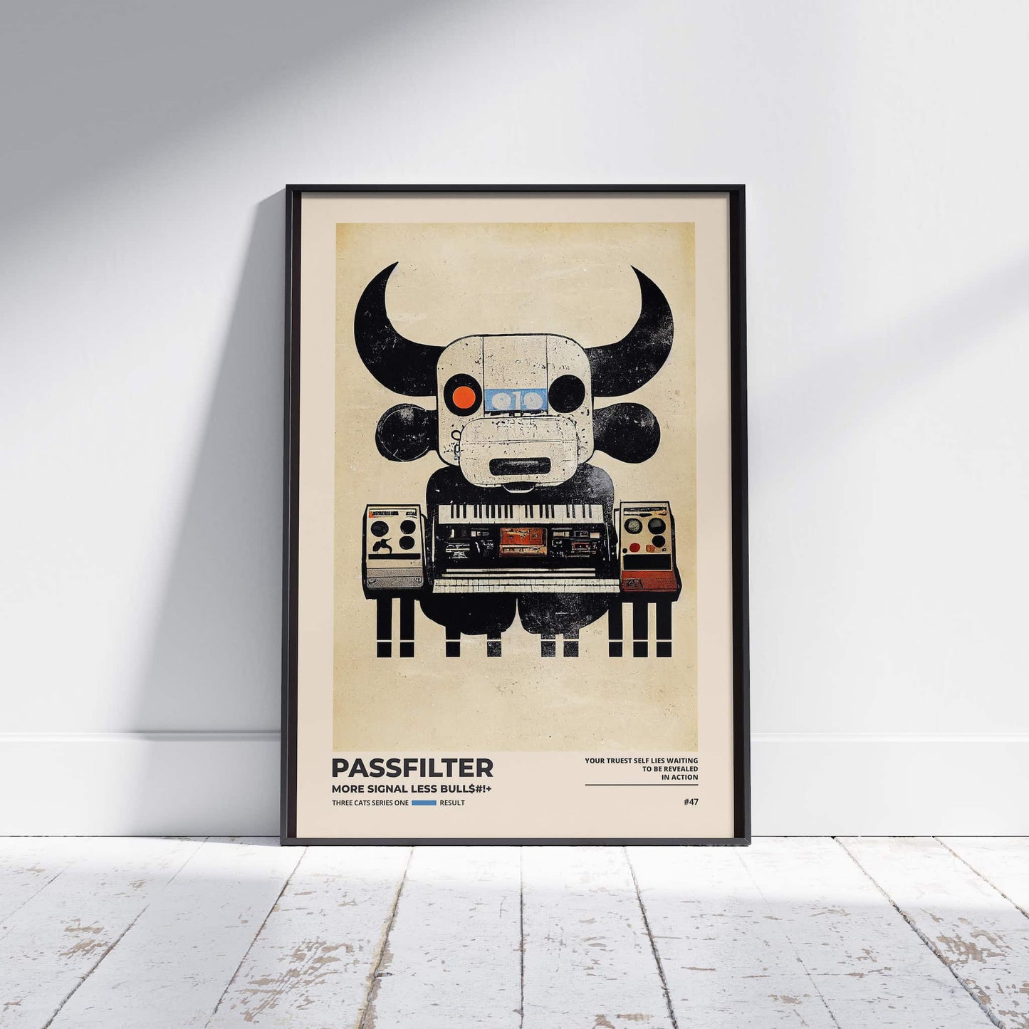 Black framed Passfilter poster sitting on a white wooden floor in a recording studio.