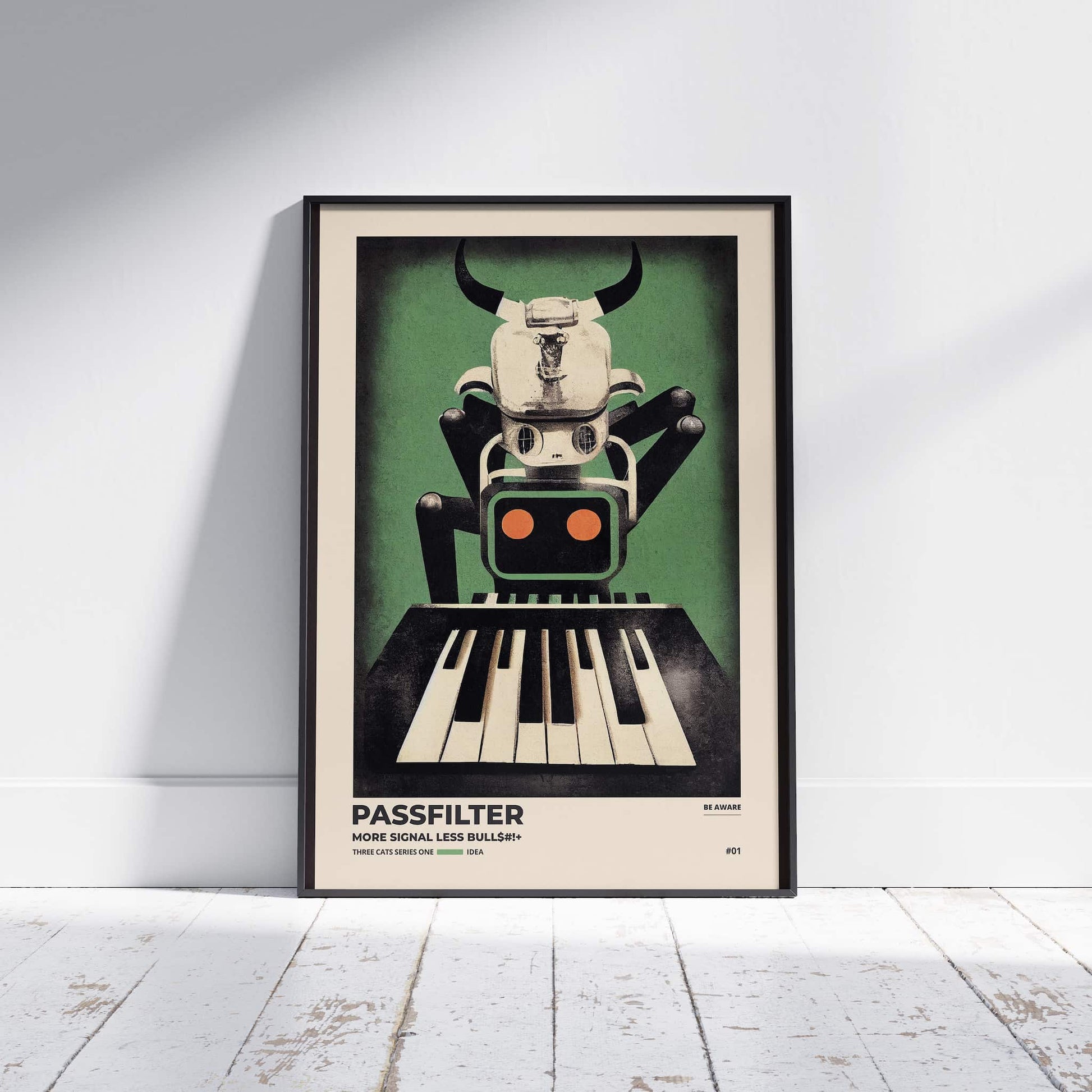 Black framed Passfilter poster sitting on a white wooden floor in a recording studio.