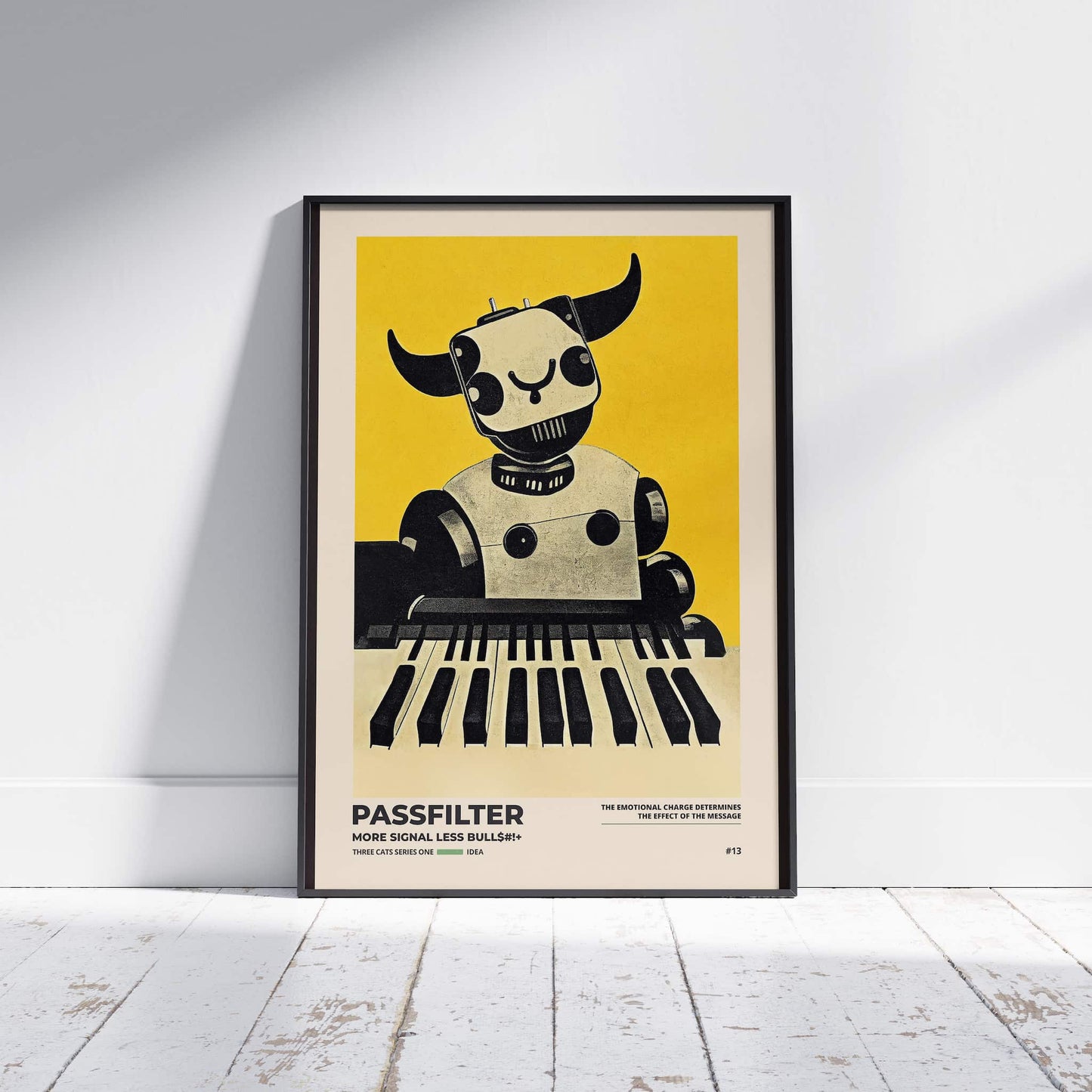 Black framed Passfilter poster sitting on a white wooden floor in a recording studio.