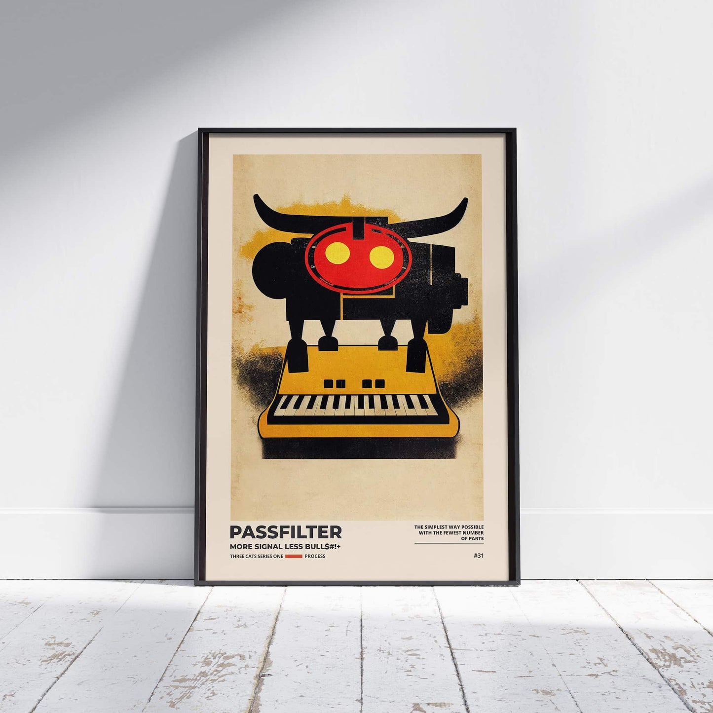 Black framed Passfilter poster sitting on a white wooden floor in a recording studio.