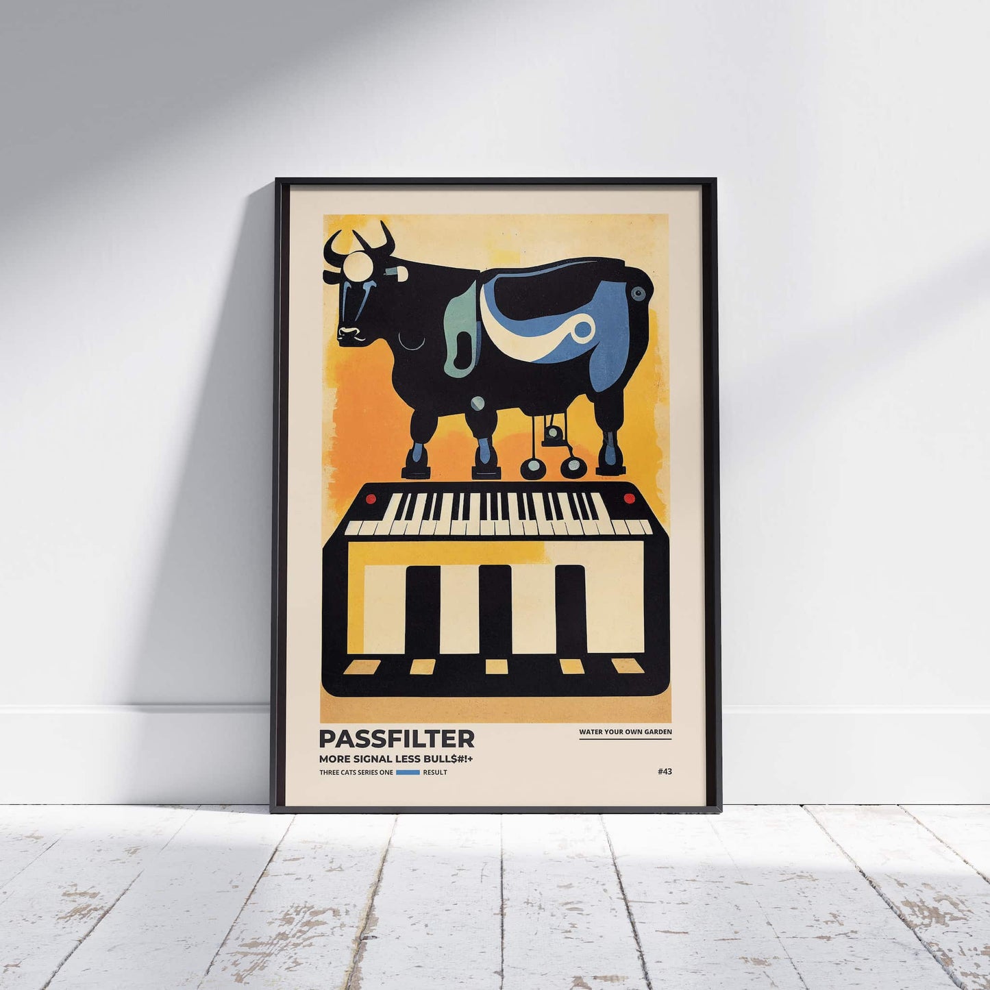 Black framed Passfilter poster sitting on a white wooden floor in a recording studio.
